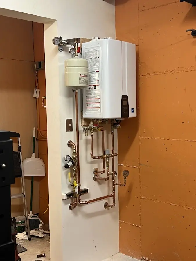 Plumbing technician inspecting water heater connections in South Daytona